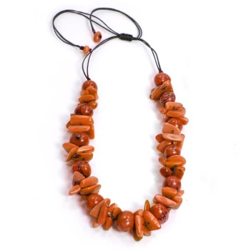 An orange necklace that is made out of a cluster of tagua.