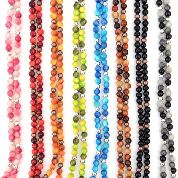 A picture of all the different colors that the peapod necklaces can come in. Those colors are, pink, red, orange, green, blue, brown, black, and grey.