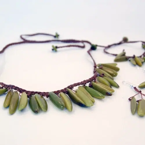 A picture of the pimiento set, made from tagua beads, on a braided cord.