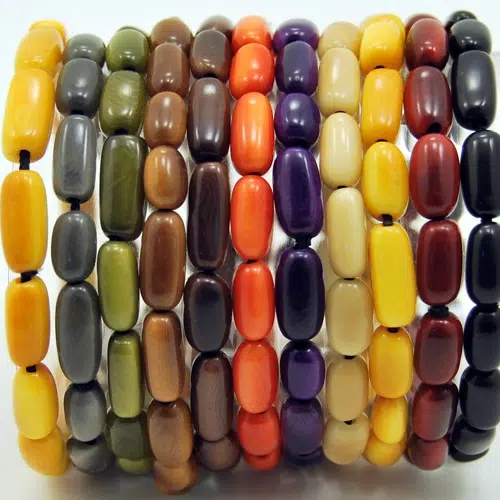 A close up picture of the fall/winter colors of the arroz bracelet, those colors are, yellow, grey, green, brown, dark brown, orange, dark purple, white, dark red, and black