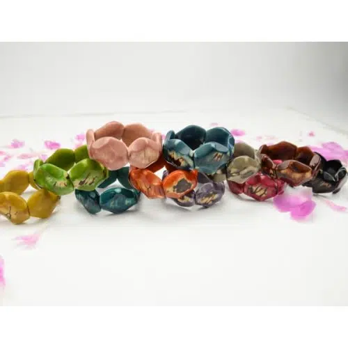 A picture of all the hex bracelets sitting on top of each other, the colors in this picture are yellow, green, turquoise, pink, orange, blue, purple, grey, red, brown, black