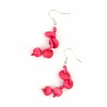 A close up picture the double strand earrings, coming in the color of pink.