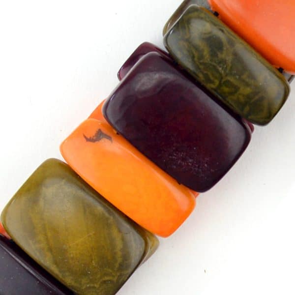 A close up picture of the red, orange, and green gradient bracelet.
