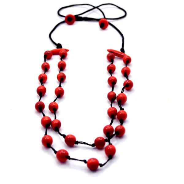 A picture of a daub necklace, made out of tagua pearls and comes in a verity of colors, the color in this picture is red.