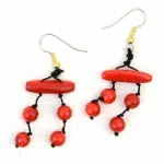 A close up of picture of the daub earrings, there color is red.