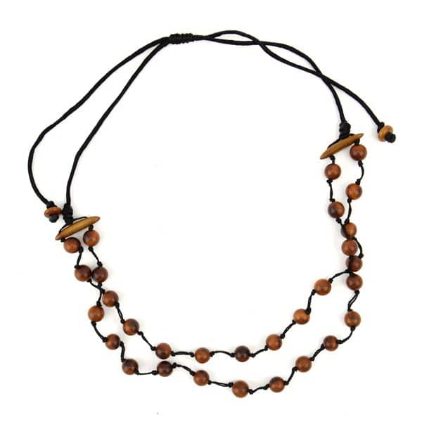 A picture of a daub necklace, made out of tagua pearls and comes in a verity of colors, the color in this picture is brown.