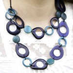 This darkly colored necklace has bubbles, and is made from tagua beads. comes in a verity of colors.