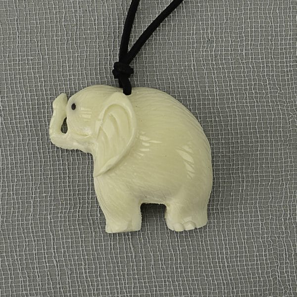 A picture of a hand carved elephant made from tagua