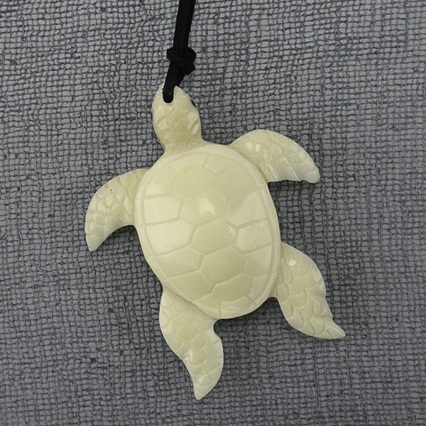 A picture of a hand carved turtle made from tagua.