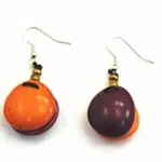A close up picture of the foluage earrings, bright orange and dark purple.