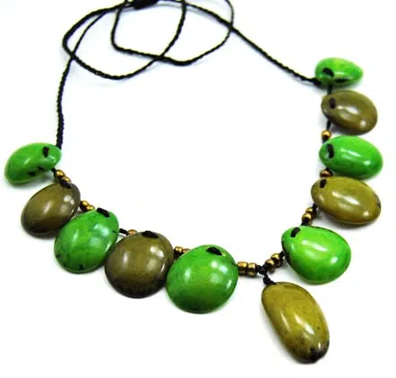 A picture of the foliage necklaces, tagua beads that have been dyed, with metal beads. the color of the dyed beads in this picture are green.