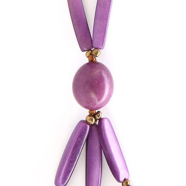 A close up picture of the purple runway necklace, showing its gem at the bottom of the necklace.
