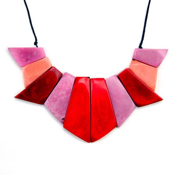 A picture of the symmetry set, carved out tagua, coming in the color of pink, dark red, red, and peach.