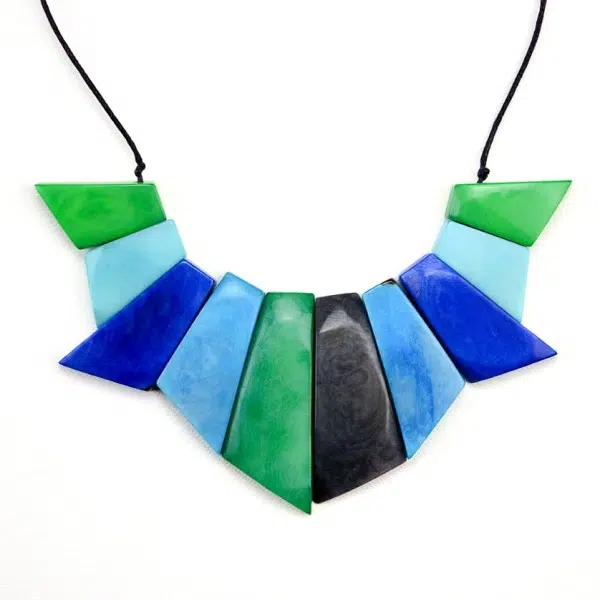 A picture of the symmetry set, carved out tagua, coming in the color of green, blue, turquoise, and black.