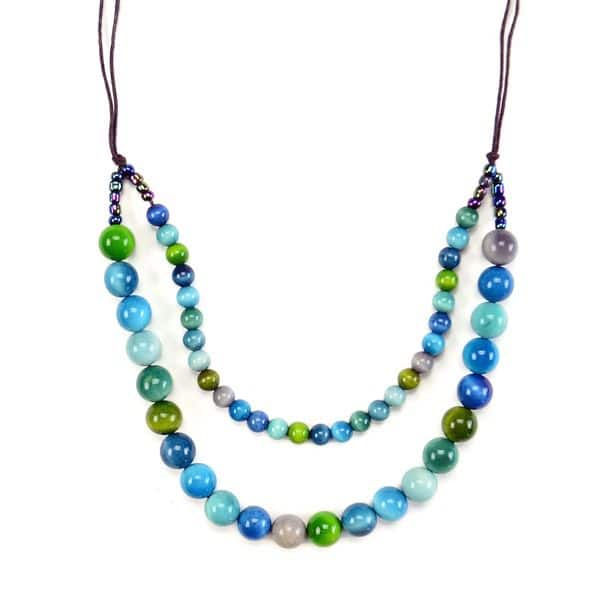 A picture of the esfera necklace, a double tier necklace. has a wide verity of glass beads. The colors of the beads on this necklace are blue, green, grey, turquoise, and sky blue.