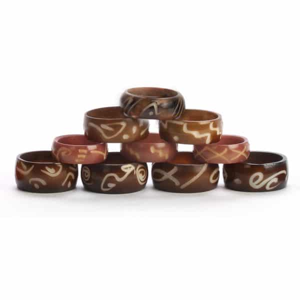 A close up picture of the tagua ring band, showing the different designs on the side.