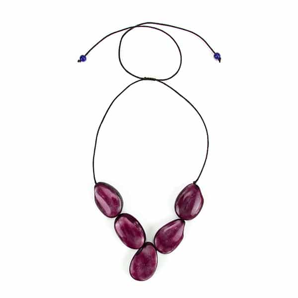 A picture of the purple cinco tagua necklace.