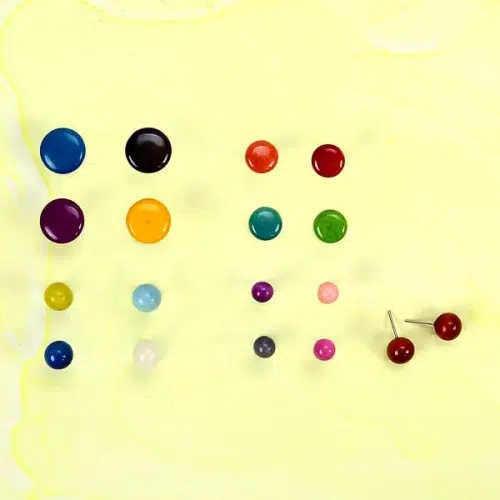 A picture of the tagua stud earrings showing the color and sizes that they come in.