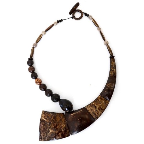 A picture of a necklace that has coco seeds and coconut slices.