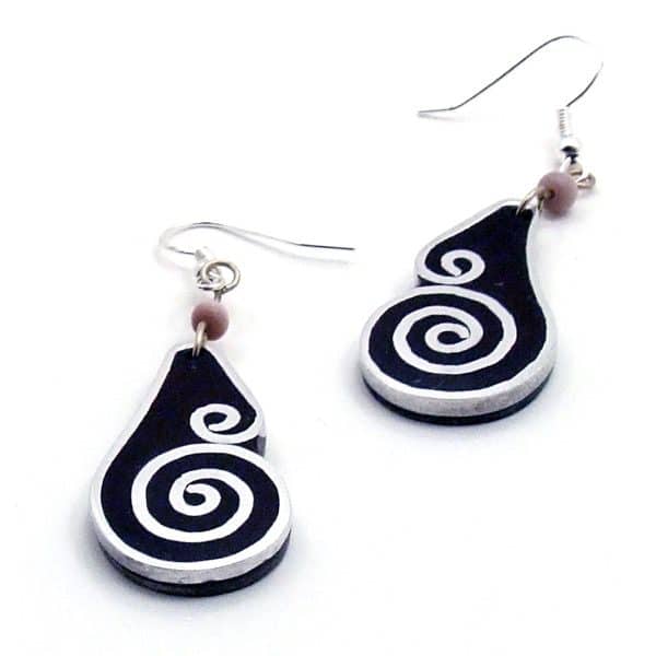 A close up picture of the aluminum inlay earring with an air like design.