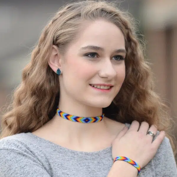 A young women wearing a woven bead bracelet.