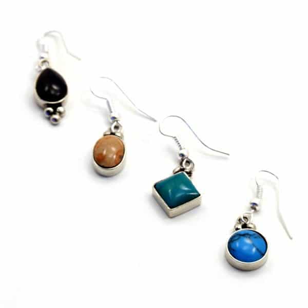 Four different jane earrings, they have different shapes, and colors, the colors are turquoise, teal, brown and black, with the shapes being, oval