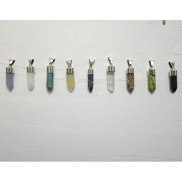 A picture of all the different colors that the pendulu necklace can come in, the colors in this picture are, purple, white, turquoise, yellow, blue, clear, brown, green, and black.