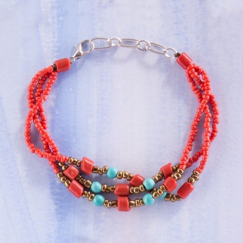 Delicate strands of coral with red and turquoise beads.