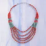 A picture of the eminence neckalce, made from coral and turquoise sets.