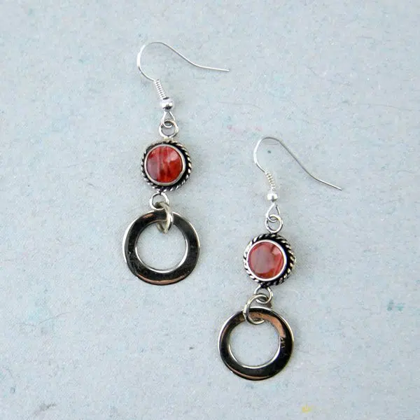 A close up pictures of the red allure earrings