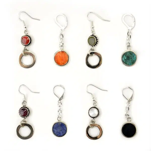 A picture of a bunch of different allure earrings, there colors are, red, orange, grey, turquoise, purple, blue, white, and black.