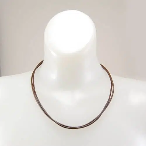 A necklace made out of two strands of leather.