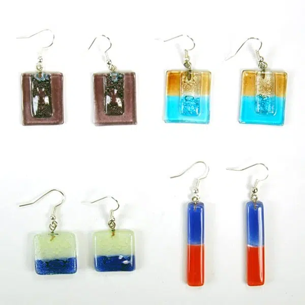 A picture of four different styles of the naked art glass earrings.