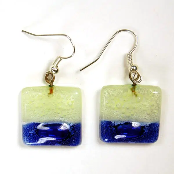 A picture of a pair of square naked art glass earrings.