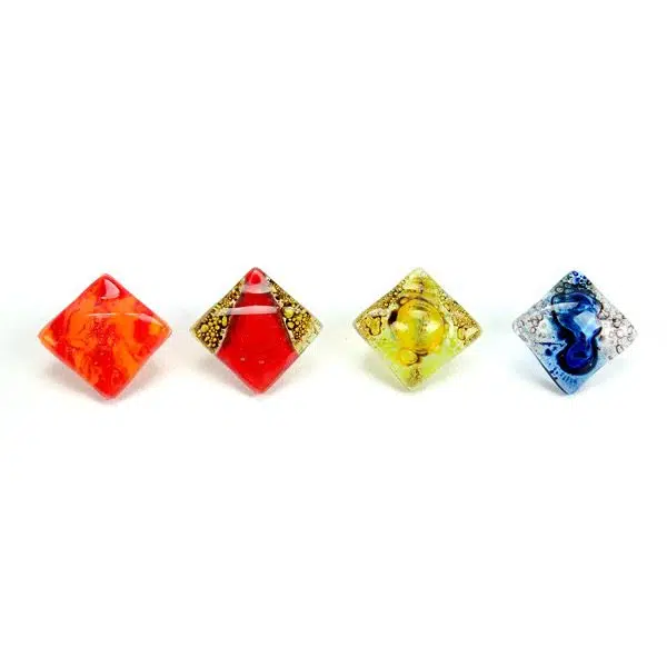 A picture of four different colors for the art glass stud, the colors in this picture are red/orange, gold/red, yellow, and clear/blue.