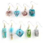 A close up picture of the art glass earrings, the colors in this picture are, red, turquoise, green, and white.