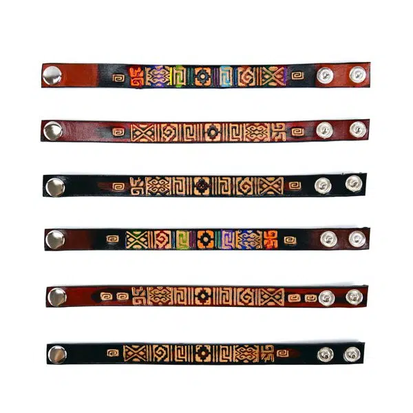 A leather bracelet with motif designs stamped on to it.