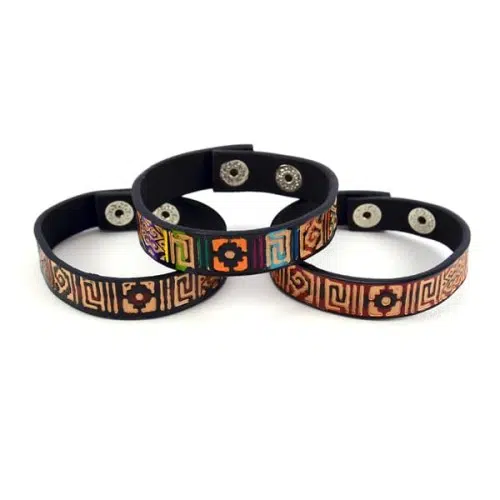 three leather totem bracelets, one bracelet sitting on top of the others.