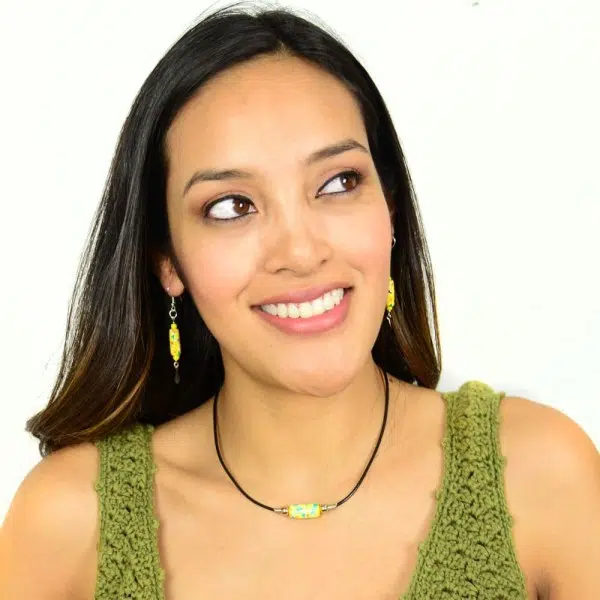 A young women wearing the yellow painted bead set.