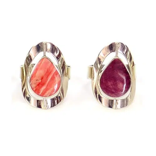 A picture of two different teardrop flip stone rings.