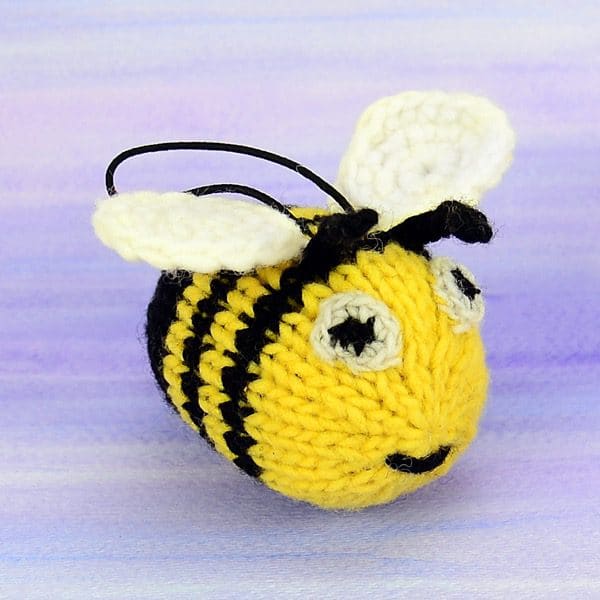 A catnip toy that looks like a bumblebee. The toy has been hand knit with wool