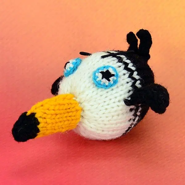 A catnip toy that looks like a toucan, The toy has been hand knit with wool