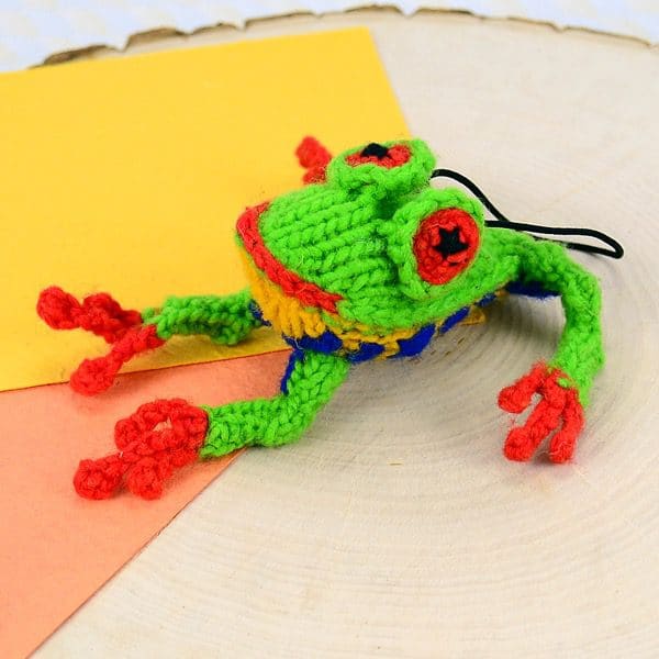 A catnip toy that looks like a frog, The toy has been hand knit with wool