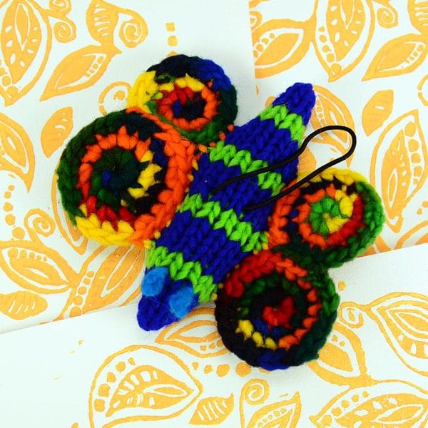 A catnip toy that looks like a Butterfly l, The toy has been hand knit with wool