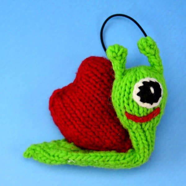 A catnip toy that looks like a snail, The toy has been hand knit with wool