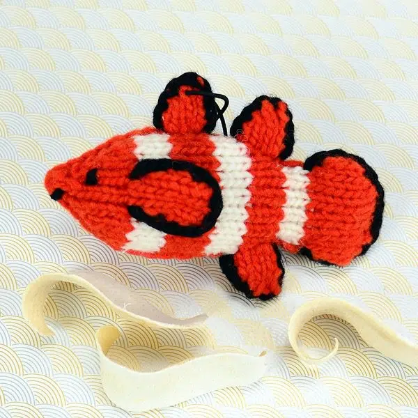 A catnip toy that looks like a clown fish, The toy has been hand knit with wool