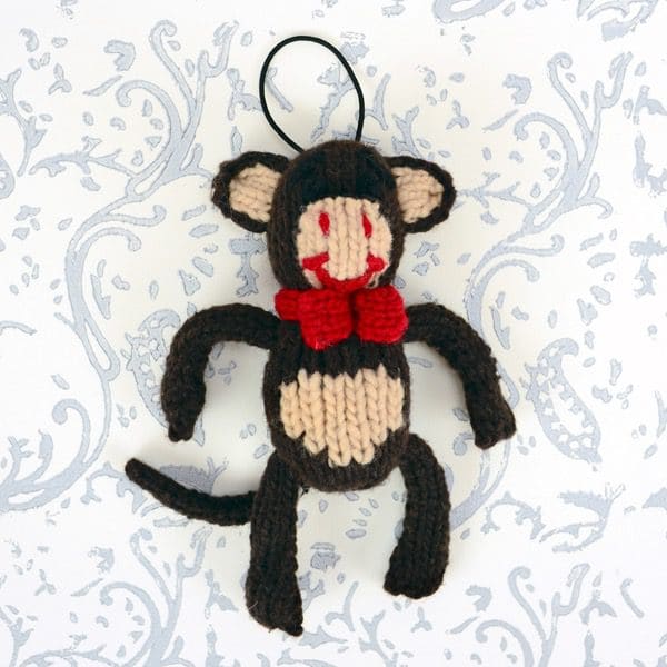 A catnip toy that looks like a monkey, The toy has been hand knit with wool