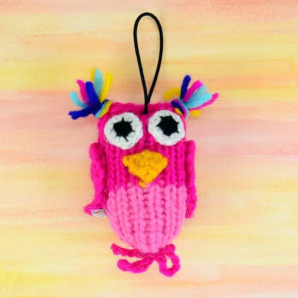 A catnip toy that looks like a pink owl, The toy has been hand knit with wool