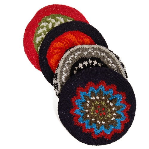 A close up of four winter berets showing the colors and designs they have
