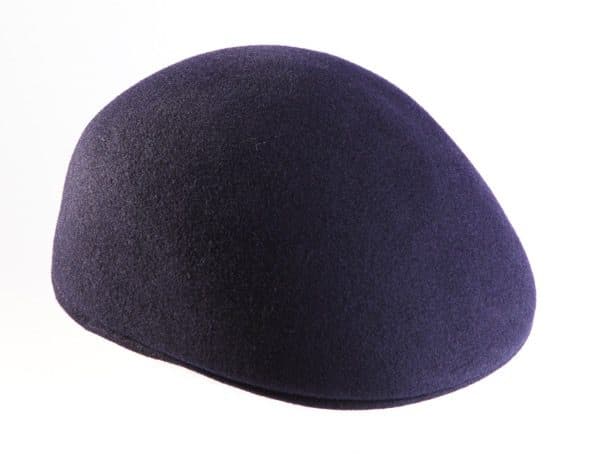 A close up of the purple wool flat cap